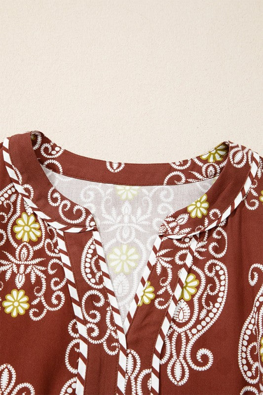 Brown garment with white and yellow floral patterns on a beige background