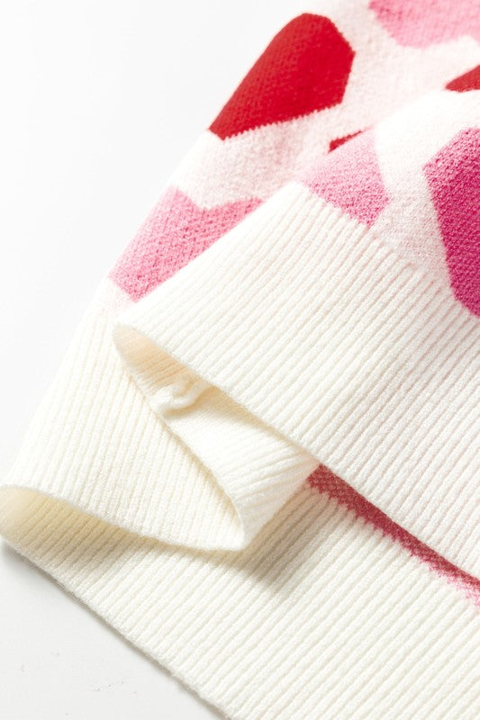 Close-up of a white towel with pink floral patterns on a light background