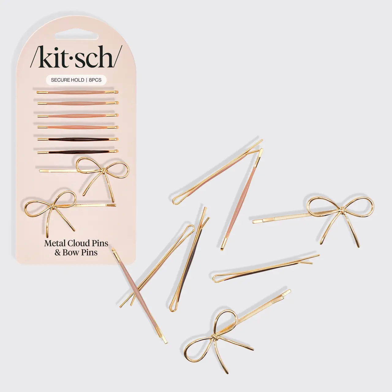 Gold metal cloud pins and bow pins with packaging on a light gray background