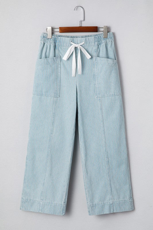 Light blue striped pants with a white drawstring on a gray background