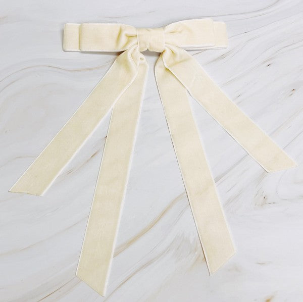 Cream-colored ribbon bow on a marble surface