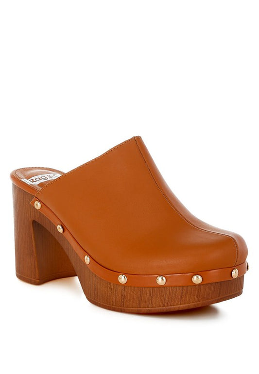 Brown clog shoe with gold studs on a white background