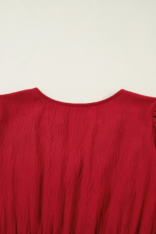 Close-up of a red garment with textured fabric on a white background