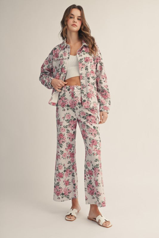 Woman wearing a floral pajama set on a plain background
