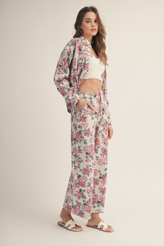 Woman wearing a floral outfit on a plain background