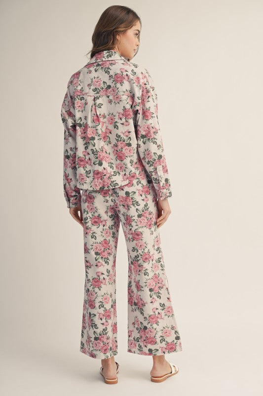 Woman wearing a floral pajama set on a plain background