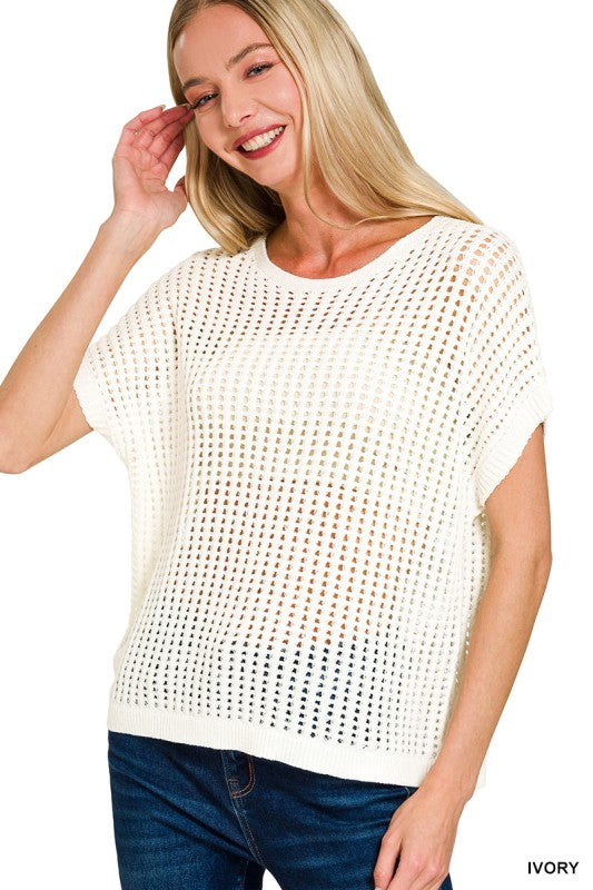 Woman wearing a white knit top with short sleeves on a white background